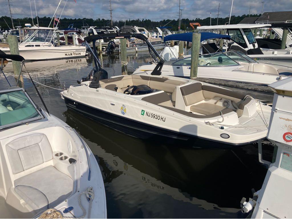 Bayliner 190 2017 Bayliner 190 boat docked at a marina with other boats.