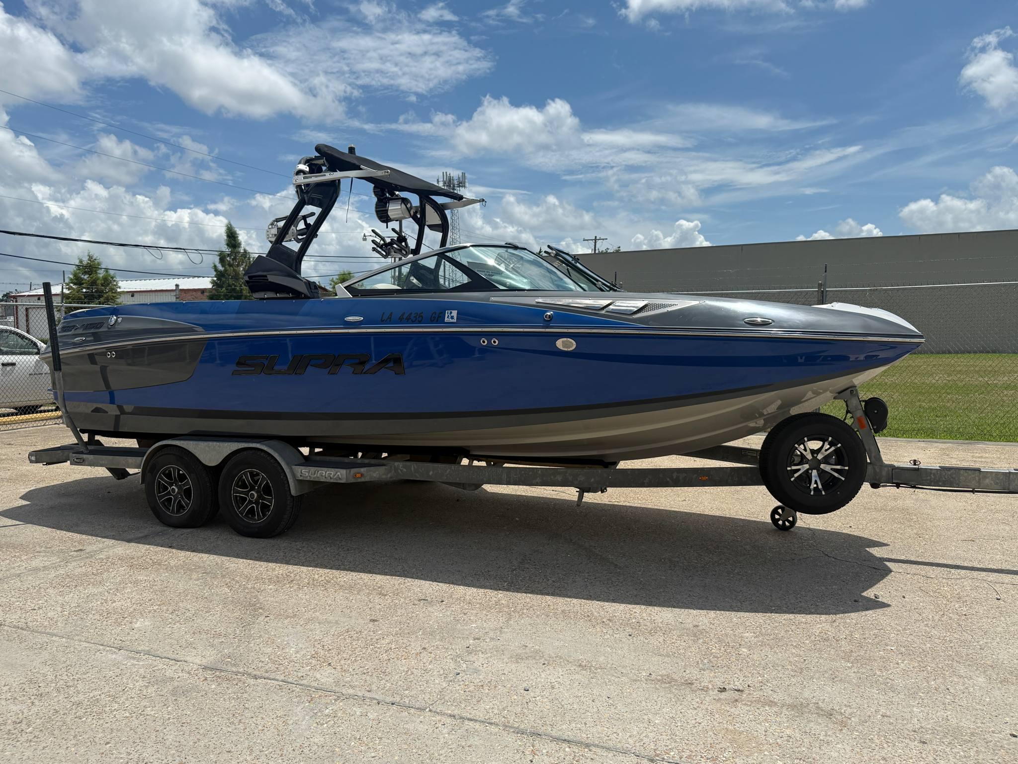 Supra SE 450 2016 Supra SE 450 boat on trailer under a clear blue sky.