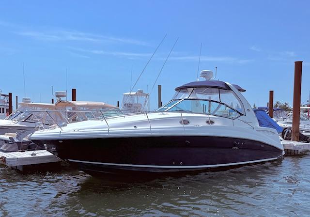 Sea Ray 320 Sundancer 2007 Sea Ray 320 Sundancer yacht docked at marina under clear blue sky.