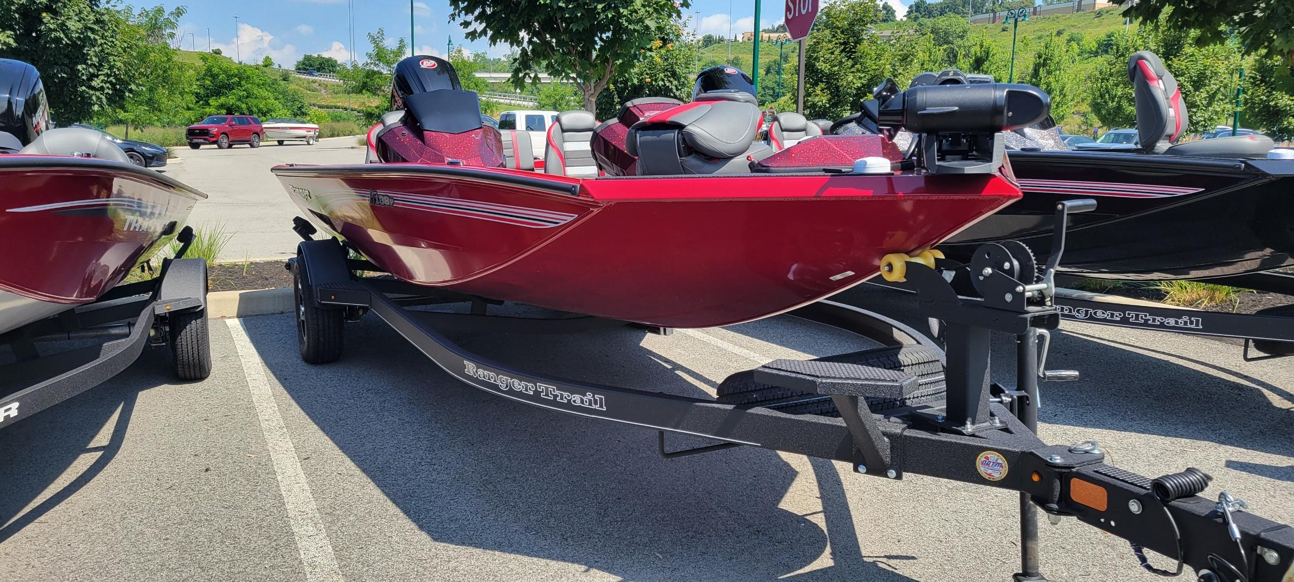 Ranger RT188P 2025 Ranger RT188P boat in red, parked on a trailer in a sunny lot.