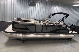 Sylvan L3 CLZ DH 2026 Sylvan L3 CLZ DH pontoon boat in showroom, sleek design, modern seating.