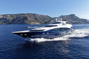 Kaiserwerft 101'9" Luxurious 2004 Kaiserwerft yacht cruising on blue waters with scenic mountain backdrop.