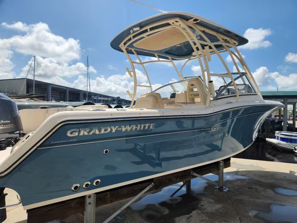 Grady-White Freedom 235 2018 Grady-White Freedom 235 boat in marina, blue hull, sunny day.