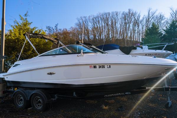 Sea Ray 220 Sundeck 2015 Sea Ray 220 Sundeck boat on trailer, parked outdoors.