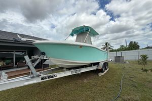 Release 208 RX 2018 Release 208 RX boat on trailer, parked in a grassy yard under cloudy sky.