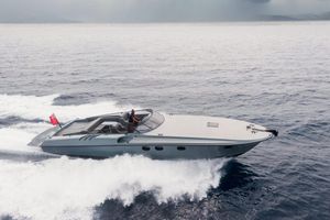 Magnum 44 Sleek 2003 Magnum 44 yacht cruising swiftly on open water.
