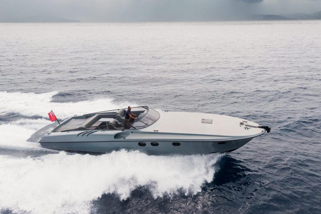 Magnum 44 Sleek 2003 Magnum 44 yacht cruising swiftly on open water.