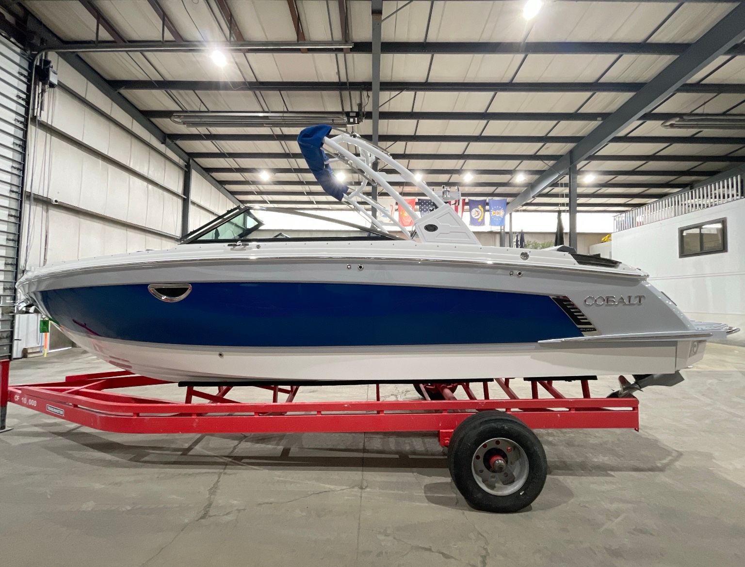 Cobalt R8 Surf 2022 Cobalt R8 Surf boat in a warehouse on a red trailer.