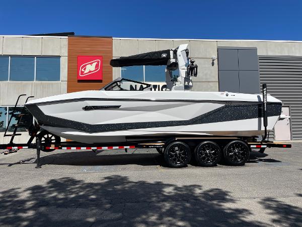 Nautique Super Air Nautique G25 2025 Nautique Super Air Nautique G25 boat on trailer, parked outside dealership.