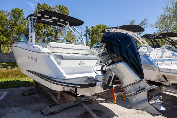 Cobalt 25SC 2019 Cobalt 25SC boat with outboard motor on display in a sunny outdoor setting.