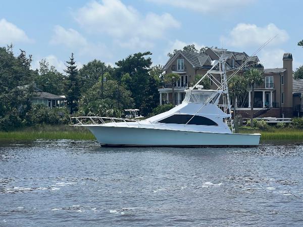 Ocean Yachts 48 Super Sport 1996 Ocean Yachts 48 Super Sport on a serene river with houses in the background.