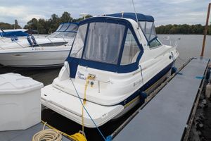 Cruisers Yachts 280 CXi Express 2004 Cruisers Yachts 280 CXi Express docked, featuring blue canopy and white hull.