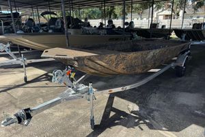 G3 Gator Tough 16 DK 2026 G3 Gator Tough 16 DK boat on trailer, camo design, parked in covered area.