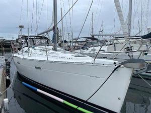 Beneteau 393 2004 Beneteau 393 sailboat docked in marina, overcast sky.