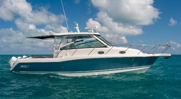 Boston Whaler 345 Conquest 2021 Boston Whaler 345 Conquest boat on clear blue ocean under a partly cloudy sky.