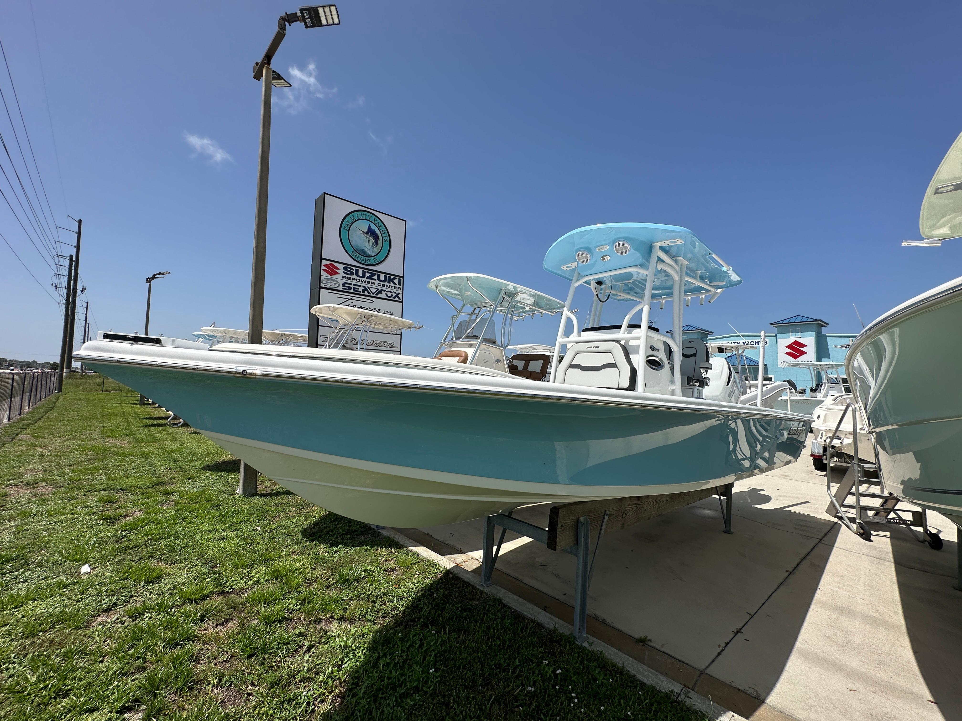 Sea Pro 250 Bay 2026 Sea Pro 250 Bay boat displayed outdoors under clear blue sky.
