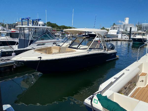 Scout 255 Dorado 2022 Scout 255 Dorado boat docked at a marina on a sunny day.