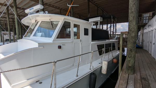 Hatteras 53 Convertible Custom 1966 Hatteras 53 Convertible Custom yacht docked under a covered marina.