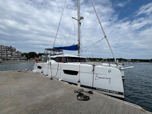 Fountaine Pajot Astrea 42 2022 Fountaine Pajot Astrea 42 catamaran docked at a marina under cloudy skies.