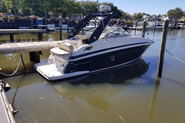 Regal 28 Express 2018 Regal 28 Express boat docked in a marina, calm water, sunny day.