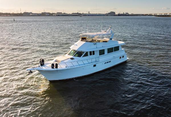 Hatteras 65 Sport Deck Motor Yacht 1998 Hatteras 65 Sport Deck Motor Yacht cruising on open water.