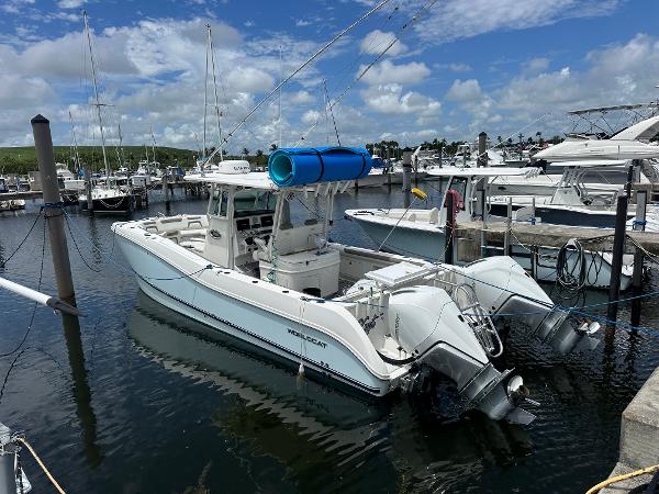 World Cat 325 CC 2020 World Cat 325 CC boat docked in marina under blue sky.