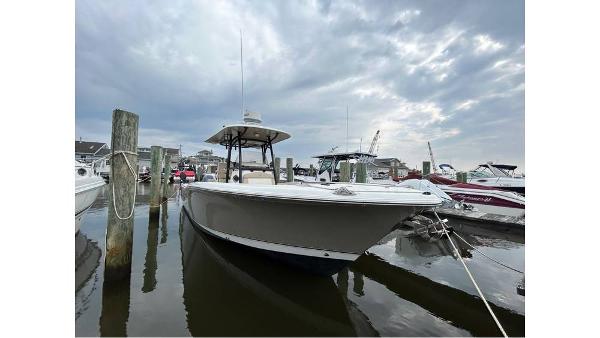 NauticStar 2800 XS 2018 NauticStar 2800 XS boat docked at a marina under a cloudy sky.