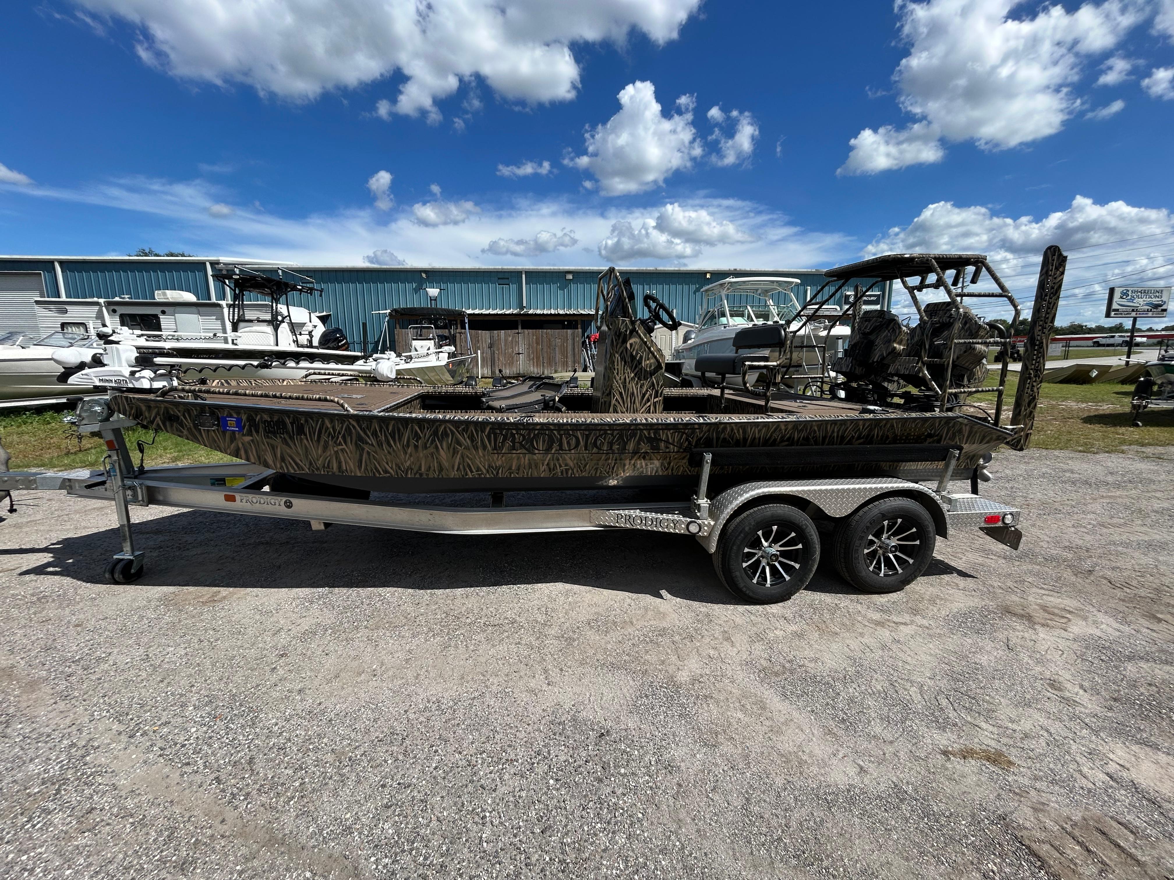 Prodigy 2070 2023 Prodigy 2070 boat on trailer under a blue sky with clouds.
