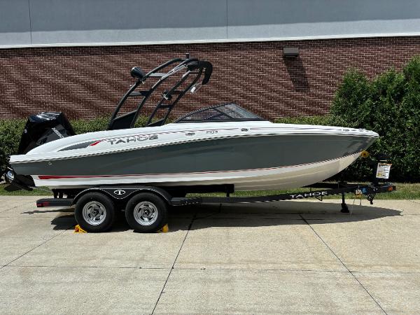 Tahoe 210 S 2024 Tahoe 210 S boat on trailer, parked outdoors.