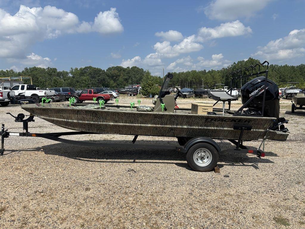 Tracker Grizzly 1860 CC 2025 Tracker GRIZZLY® 1860 CC boat on trailer, parked outdoors under a cloudy sky.