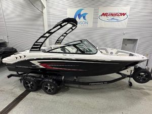 Chaparral 21 SSi 2025 Chaparral 21 SSi boat on trailer in showroom, black and white design.