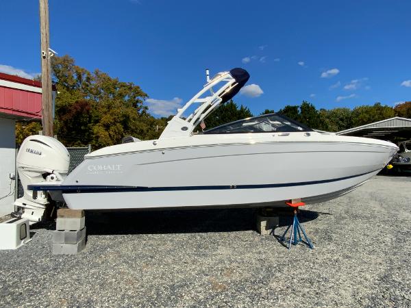 Cobalt R6 Outboard 2025 Cobalt R6 Outboard boat on display, white exterior, parked on gravel.