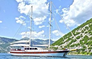 Ketch Laminated Mahogany 7 cabins 2004 Ketch Laminated Mahogany yacht with 7 cabins sailing near scenic mountains.