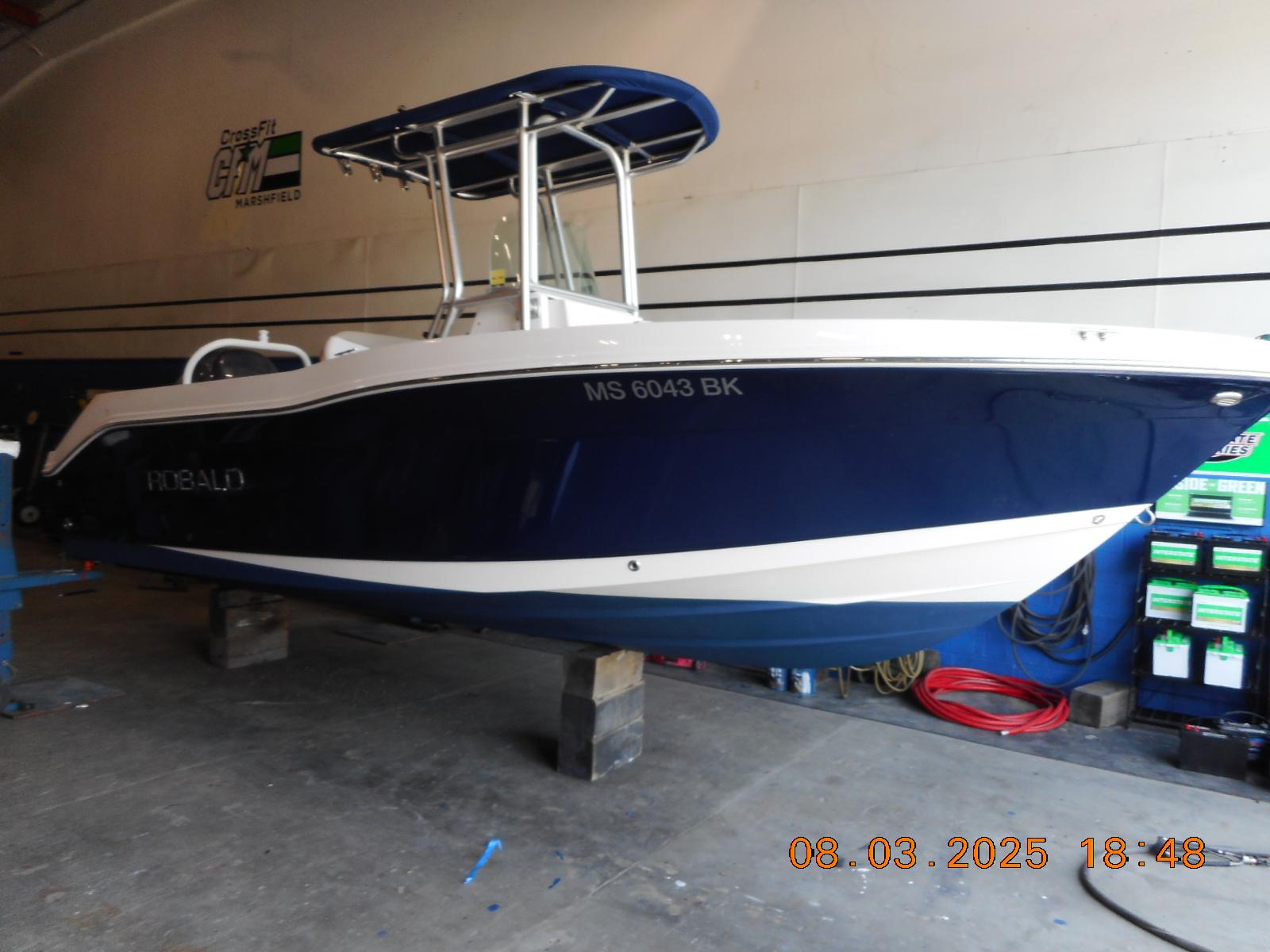 Robalo R200 Center Console 2013 Robalo R200 Center Console boat in a garage setting.