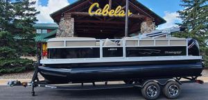 Ranger Reata 200C 2024 Ranger Reata 200C pontoon boat on trailer outside Cabela's store.