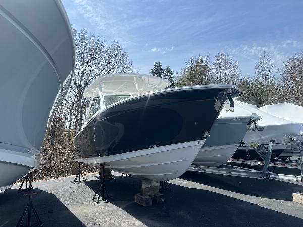 Blackfin 272DC 2024 Blackfin 272DC boat on stands in outdoor storage.