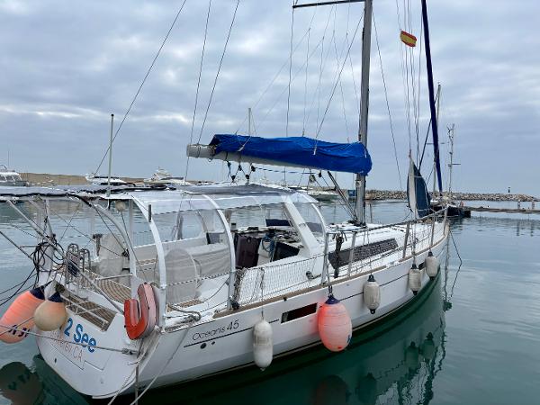 Beneteau Oceanis 45 2015 Beneteau Oceanis 45 sailboat docked in a marina under cloudy skies.