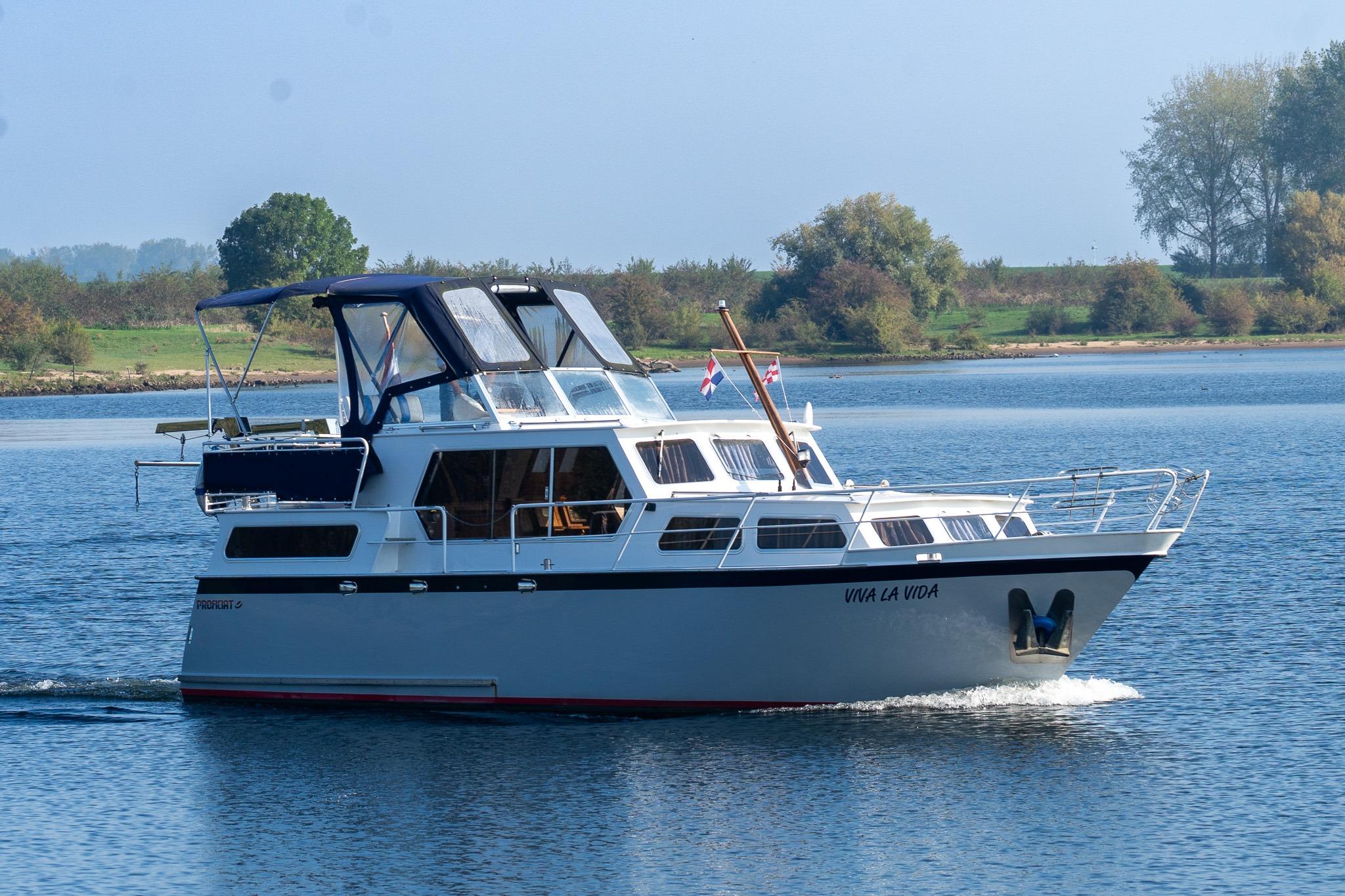 Proficiat 1010 Proficiat 1010 motor yacht from 1996 cruising on a serene lake.