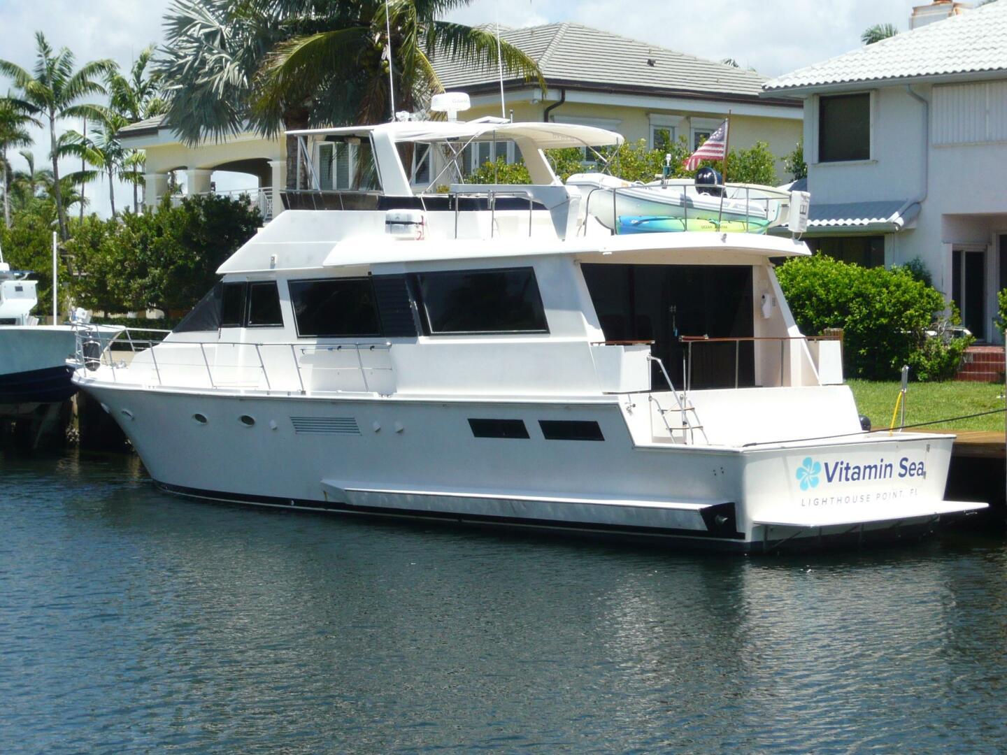 Viking Cockpit Motor Yacht 1990 Viking Cockpit Motor Yacht docked near waterfront homes.