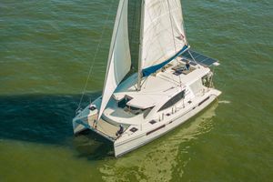 Leopard 48 2016 Leopard 48 catamaran sailing on open water, showcasing sleek design and solar panels.