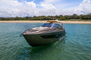 Cranchi Z35 2018 Cranchi Z35 yacht on serene water near a sandy beach.