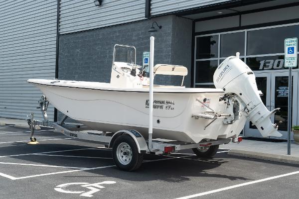 Carolina Skiff 17 LS 2024 Carolina Skiff 17 LS boat on a trailer in a parking lot.
