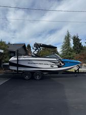 Nautique Super Air Nautique G21 2014 Nautique Super Air Nautique G21 boat on trailer, parked outdoors.