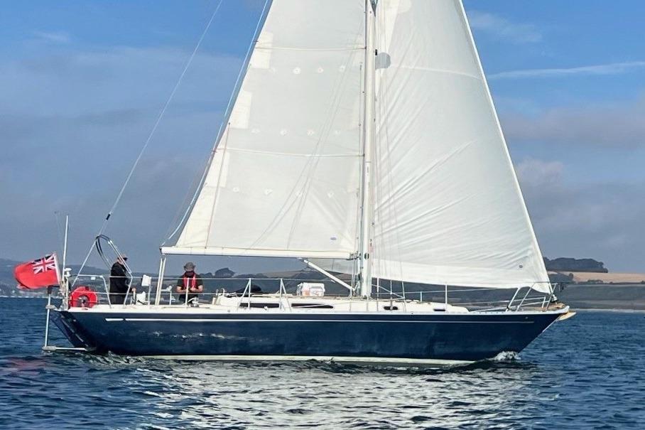 Rustler 36 Sailing yacht Rustler 36, 2001 model, cruising on calm waters under clear skies.