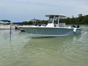 Sea Hunt Gamefish 25 2022 Sea Hunt Gamefish 25 boat anchored in calm waters near a shoreline.