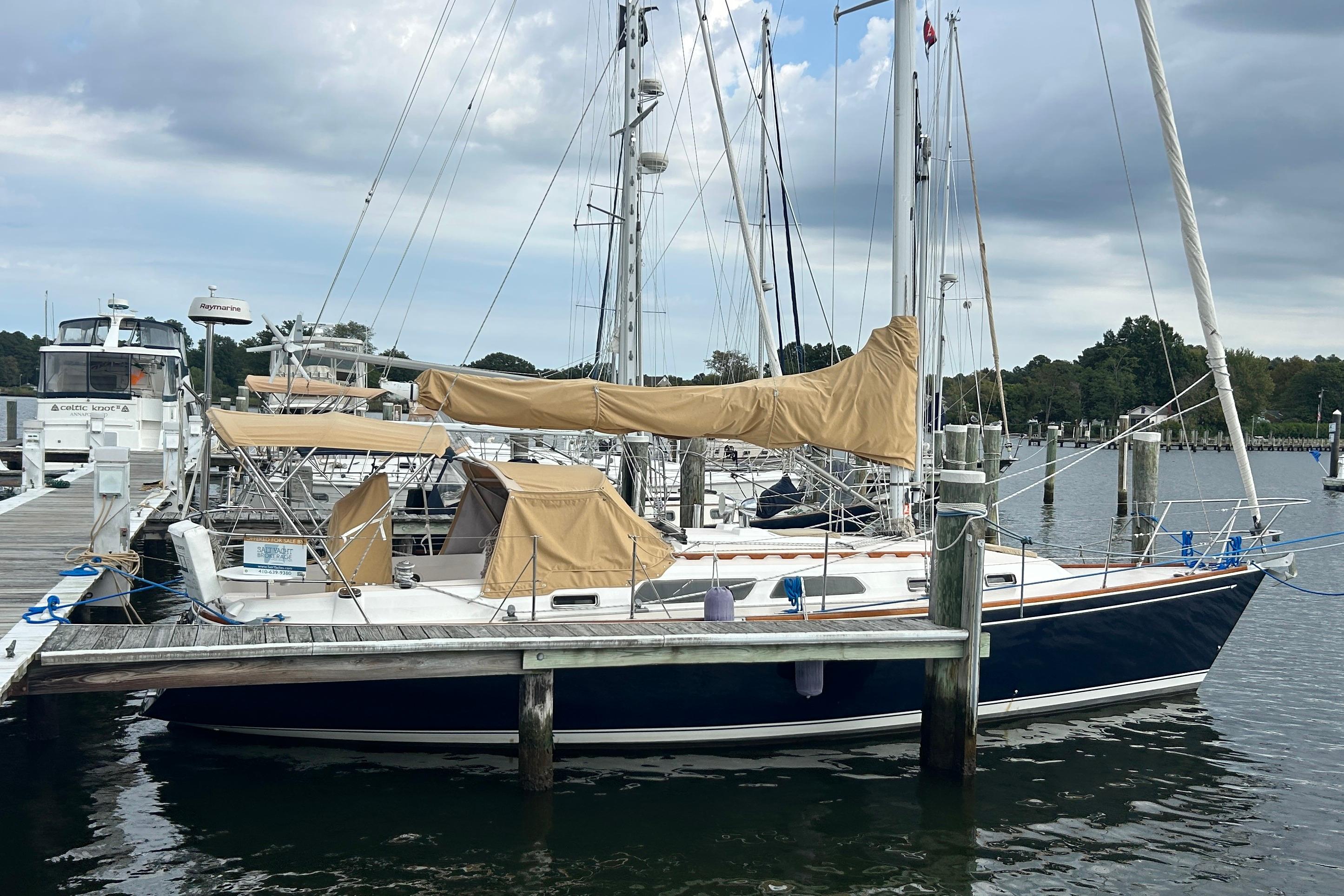 Sabre 362 2002 Sabre 362 sailboat docked at marina under cloudy sky.
