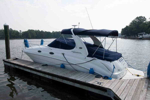 Sea Ray 280 Sundancer 2007 Sea Ray 280 Sundancer docked at a serene lakeside pier.