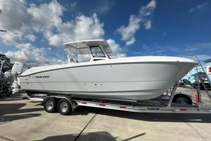 Twin Vee 280 GFX2 CC 2026 Twin Vee 280 GFX2 CC boat on trailer under blue sky.