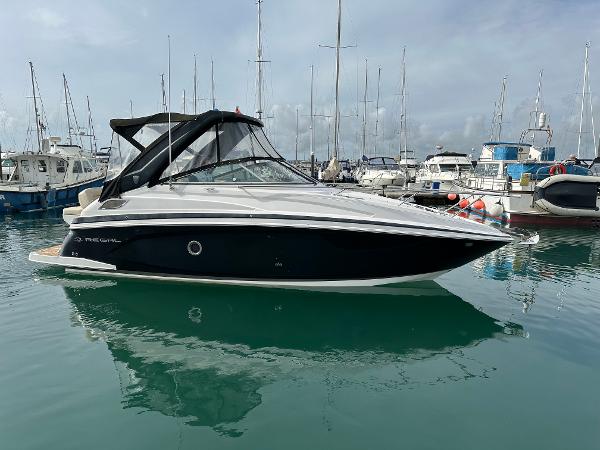 Regal 28 Express 2018 Regal 28 Express boat docked in a marina with other vessels.