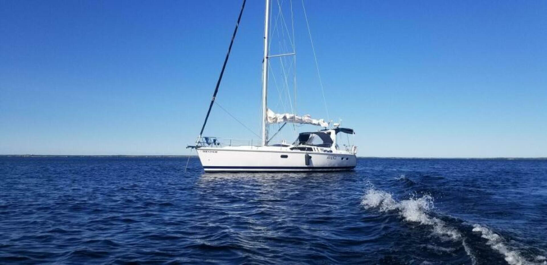 Hunter 430 Sailboat Hunter 430, 1995 model, cruising on calm blue waters under clear sky.